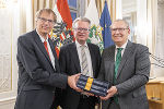 Landeshauptmann Christopher Drexler mit den Herausgebern Klaus Poier (r.) und Bernd Wieser (l.) im Weißen Saal der Grazer Burg. © Land Steiermark/ Binder